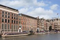 Ancient mansions with moored tour boats, Amsterdam, Netherlands